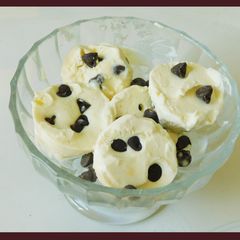 A picture of Pine apple ice cream with chocolate chips.