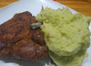 Una foto de T-Bone de cerdo en cerveza roja y puré de papa con crema de apio