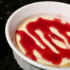 A picture of Mini Cheesecakes with Raspberry Sauce.