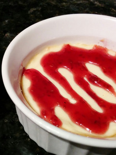A picture of Mini Cheesecakes with Raspberry Sauce.