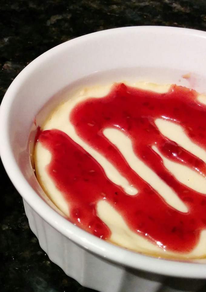 A picture of Mini Cheesecakes with Raspberry Sauce.
