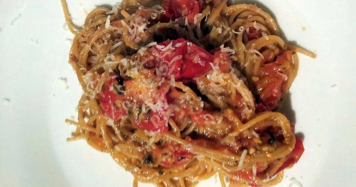 Baked breadcrumb tomatoes on garlic parmesan spaghettini. Recipe by