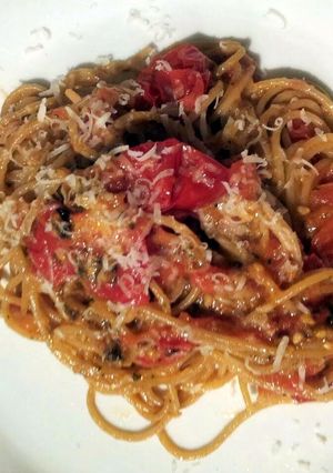 A picture of Baked breadcrumb tomatoes on garlic parmesan spaghettini..