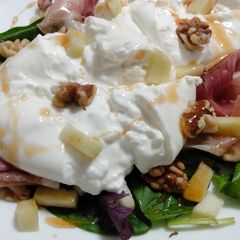 A picture of Burrata with prosciutto, honey-poached apple, and walnuts.