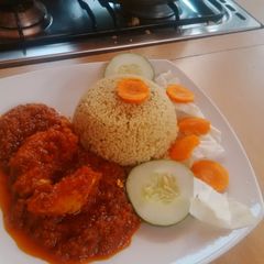 A picture of Curry rice and tomato stew.