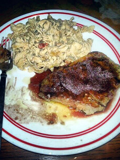 A picture of new york steak on red wine sauce.