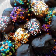 A picture of red velvet and chocolate covered fried banana balls.