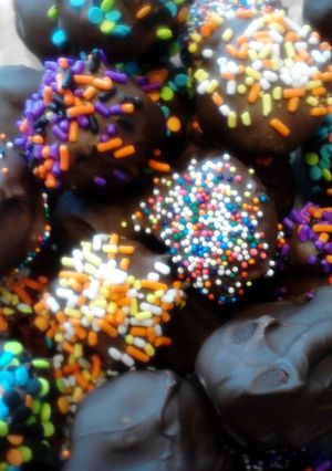 A picture of red velvet and chocolate covered fried banana balls.