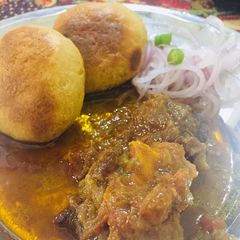 A picture of Litti with mutton korma.