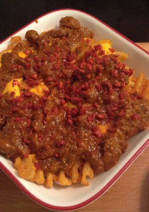 A picture of Layered Bacon Chili Cheddar Cheese Waffle Fries.