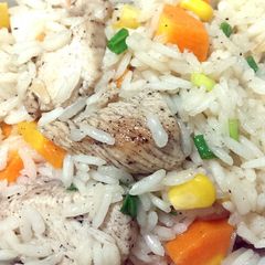 A picture of Rice with chicken and vegetables.