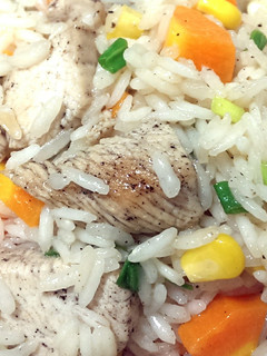 A picture of Rice with chicken and vegetables.