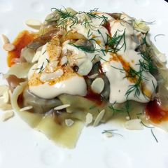 A picture of Ravioli With Alfredo Sauce Top Spicy Butter And Toasted Almond Slice.