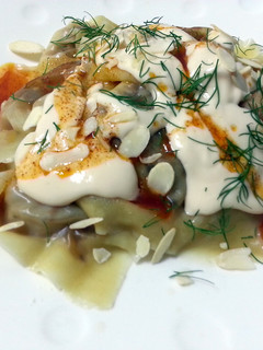 A picture of Ravioli With Alfredo Sauce Top Spicy Butter And Toasted Almond Slice.