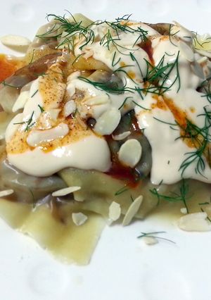 A picture of Ravioli With Alfredo Sauce Top Spicy Butter And Toasted Almond Slice.
