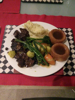 A picture of Beef in Guinness with celeriac purée,Yorkshire pudding and veggies.