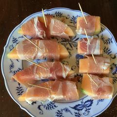 A picture of California Farm Dried Meat Wrapped Melon Tapas.