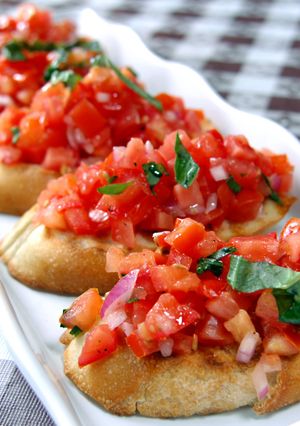 A picture of Bruschetta w/ Goat Cheese on Crackers.