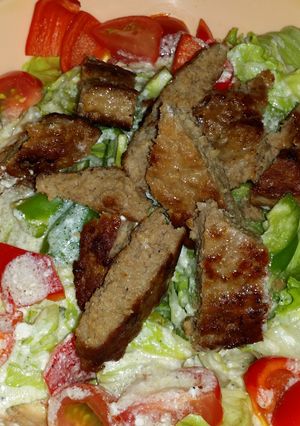 A picture of Caesar saled with beef and a twist.