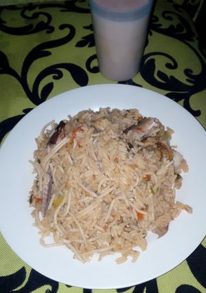 A picture of Rice and pasta jallof with fish.