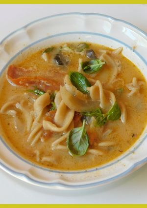 A picture of Spicy, cheesy Tomato, mushroom noodle soup.