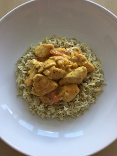 A picture of Chicken curry with brown rice.