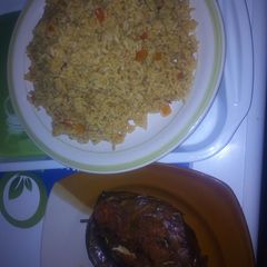 A picture of Peppered dried fish with jollof rice.