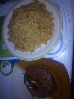 A picture of Peppered dried fish with jollof rice.