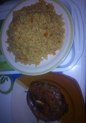 A picture of Peppered dried fish with jollof rice.