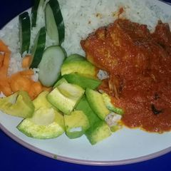 A picture of Rice and tomatoes stew with veggies.