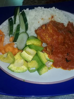 A picture of Rice and tomatoes stew with veggies.