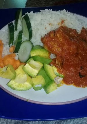 A picture of Rice and tomatoes stew with veggies.