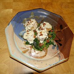 A picture of Seared Scallops with Wine Cream Sauce on Wilted Spinach.