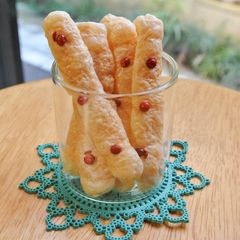 A picture of Cheese crackers with pink peppers.