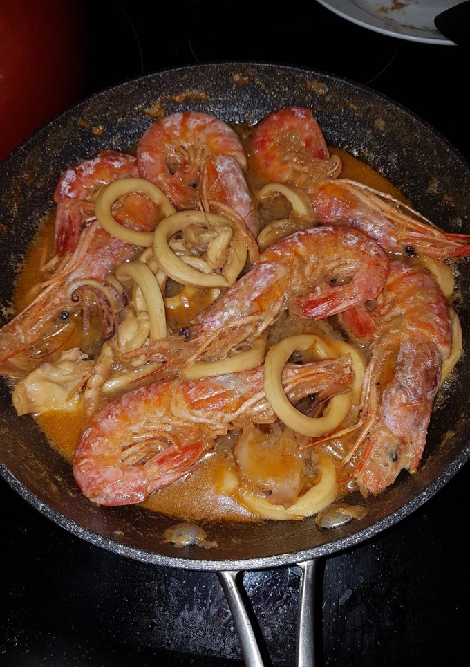 Una foto de Calamares encebollados con gambas
