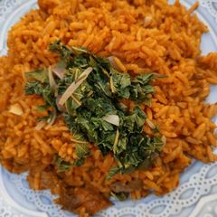 A picture of Jalof rice with steamed spinach 🤩.
