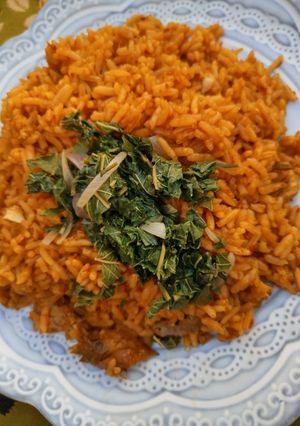 A picture of Jalof rice with steamed spinach 🤩.