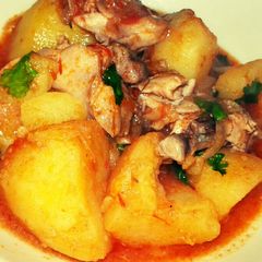 A picture of Turmeric rosemary potatoes with chicken pieces.