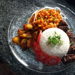 A picture of Carrot sauce, baked beef and potatoes and rice.