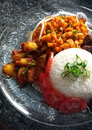 A picture of Carrot sauce, baked beef and potatoes and rice.