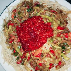 A picture of Pasta with veggies and surce.