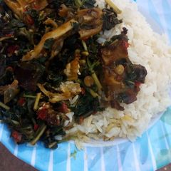 A picture of White rice and vegetable soup.