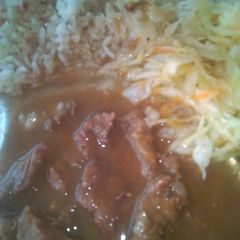 A picture of Beef stew and steamed cabbage.