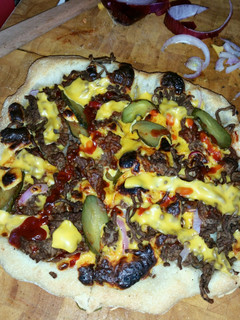 A picture of Wood fired cheeseburger pizza.
