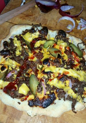 A picture of Wood fired cheeseburger pizza.