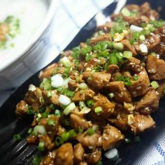 A picture of Chicken soy sauce with rice congee or plain rice soup.
