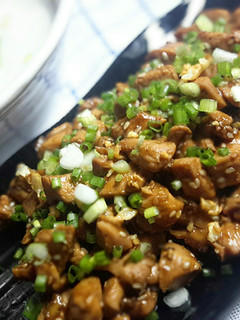 A picture of Chicken soy sauce with rice congee or plain rice soup.