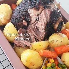 A picture of Slow Roasted Lamb Leg with Potatoes, Peas, Carrots & Corns.