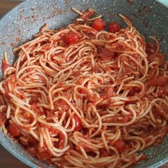 A picture of Spaghetti with marinara sauce.