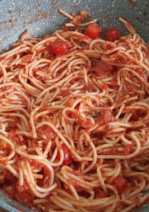 A picture of Spaghetti with marinara sauce.